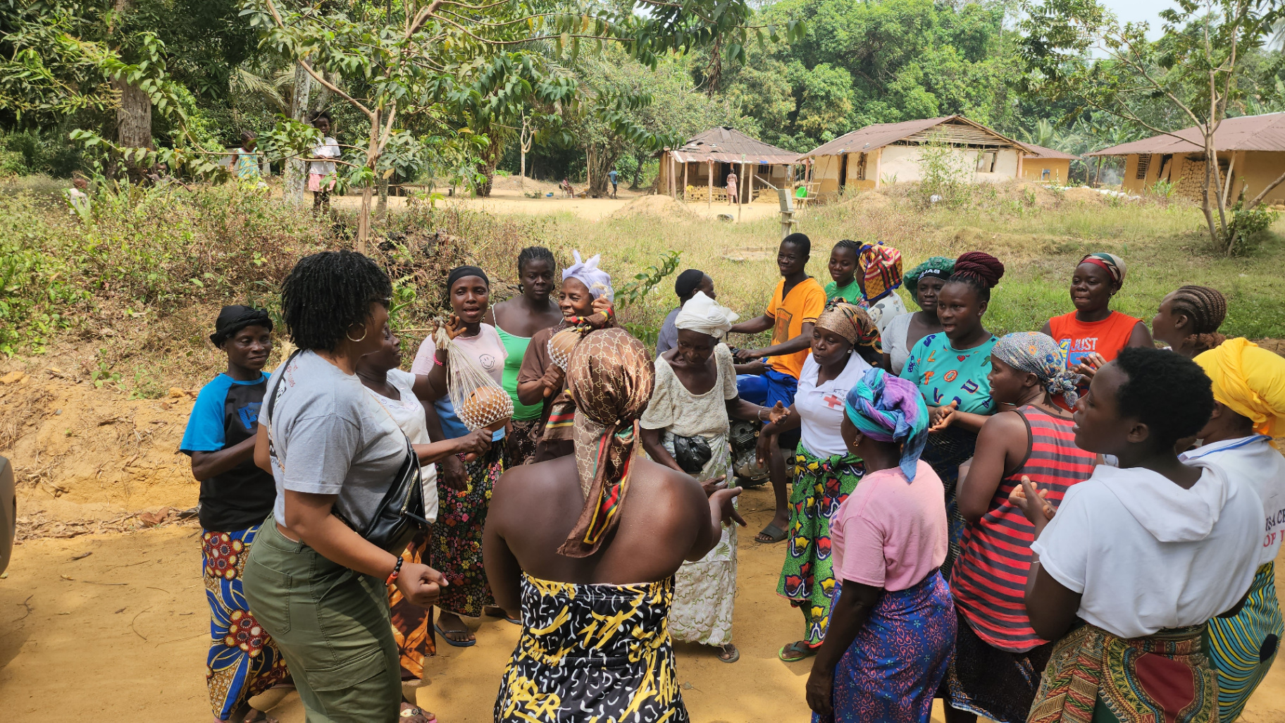 Women of Malema Town celebrating with Albertina Nyantee during a KRN community visit in Liberia