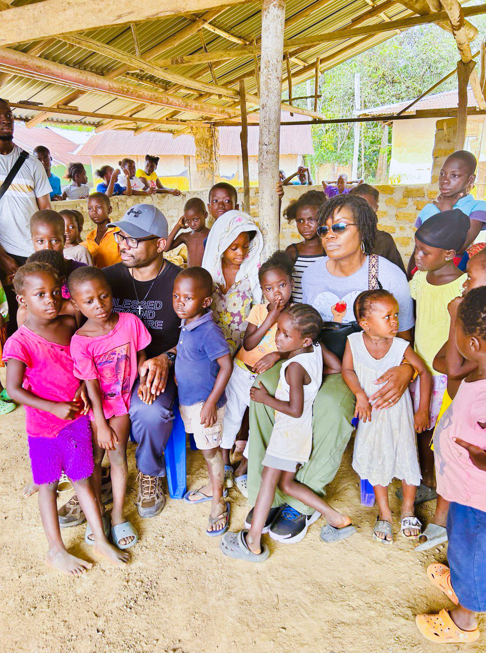 Albertina and Alastair Nyantee with village children during a KRN community outreach visit in Liberia