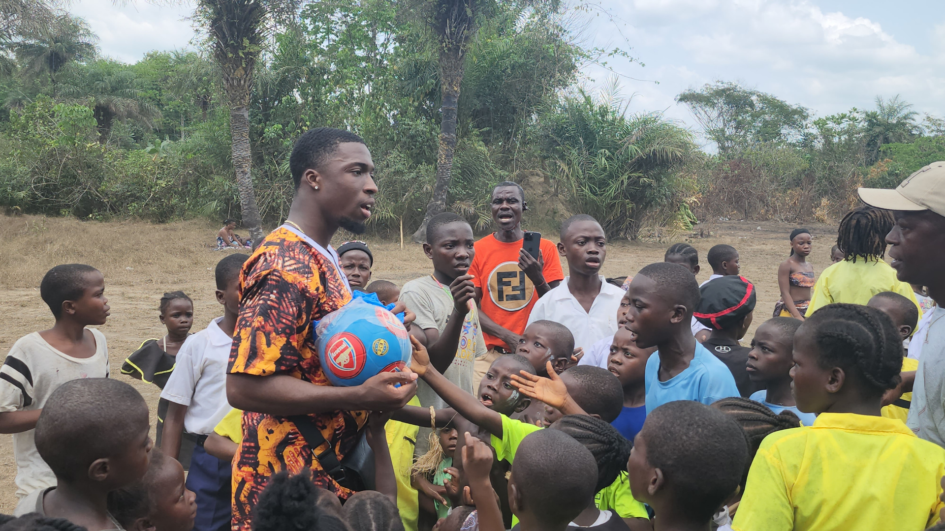 KRN team giving soccer balls to children in Liberia